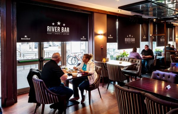 River bar restaurant interior with black window blinds